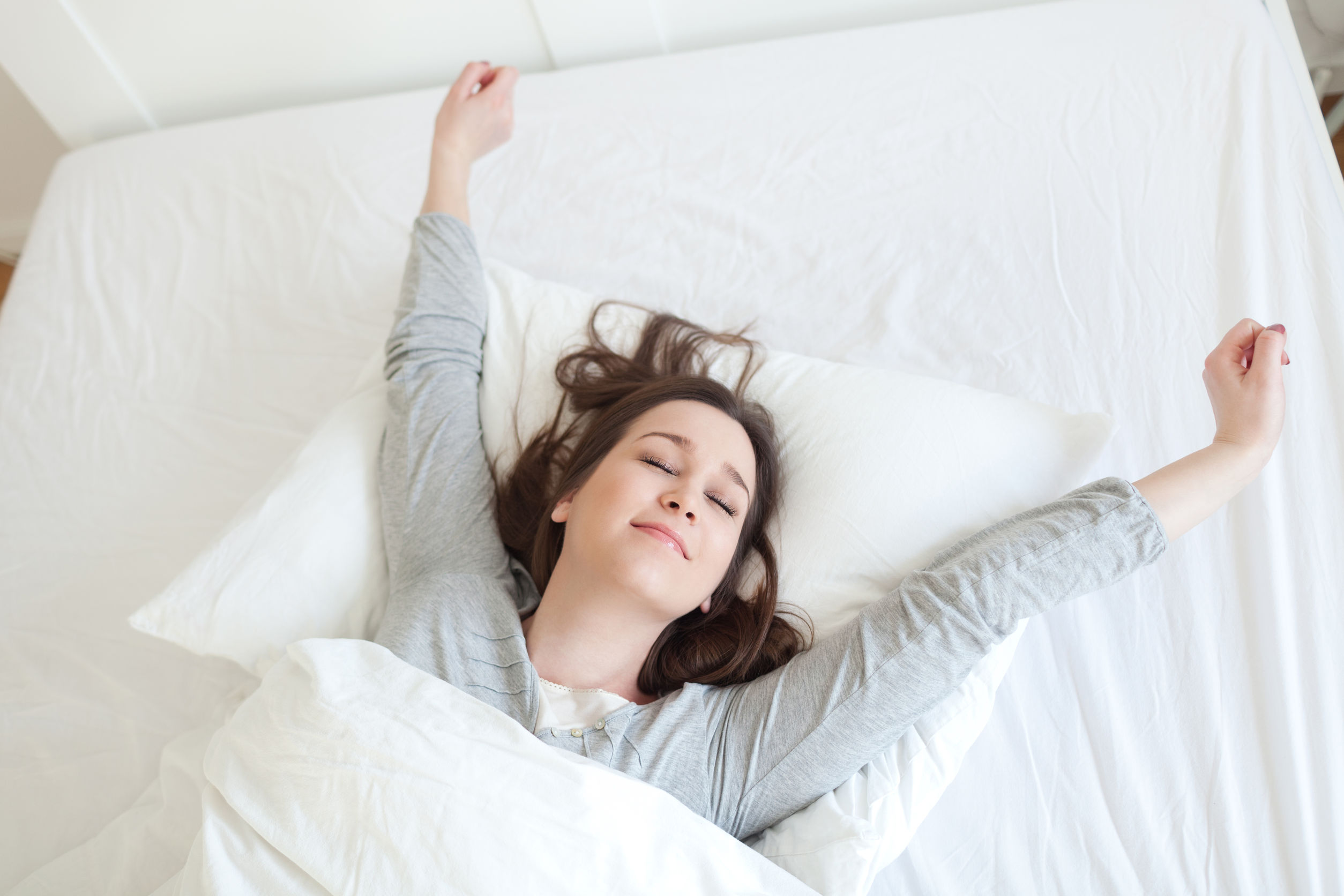 woman waking up on a comfotable mattress